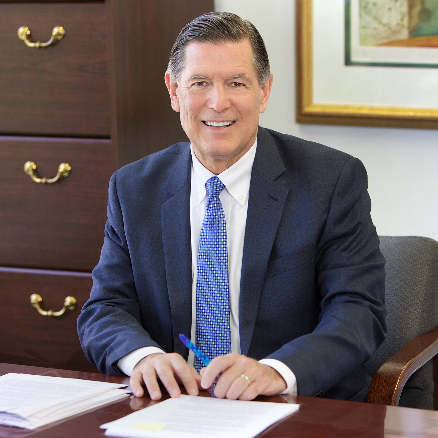 Picture of Wayne Tatusko founder of Tatusko Kennedy sitting at his desk